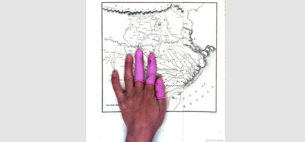 The hand of an anonymous person of color employed to digitize a google book. Screenshot from the Google books website.